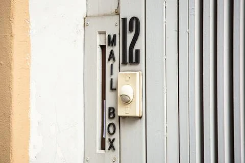 White bell switch in front of the house. Stock Photos