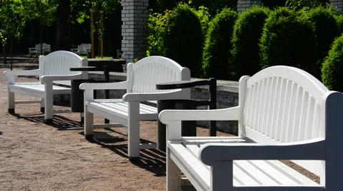 White benches in park Stock Footage 40667710
