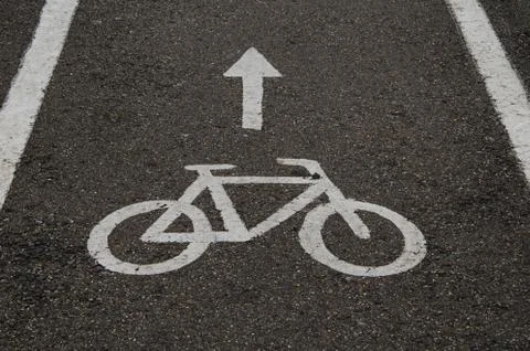 White "Bicycle Path" sign painted on the asphalt. Stock Photos