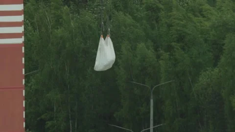 White big bag full of building materials suspended by crane chains during Stock Footage 329213689
