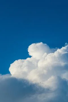 White big cloud on a blue sky in the middle of the day Stock Photos