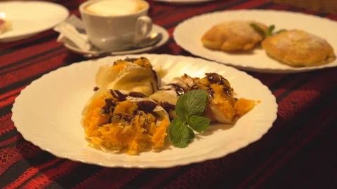 On a white big plate lies a portion of pumpkin pancakes. beautiful serving of Stock Footage 81961060