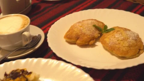 On a white big plate lies a portion of pumpkin pancakes. beautiful serving of Stock Footage 81962644