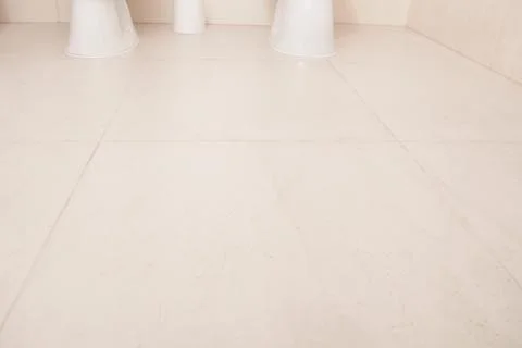 White big tile floor background. Clean surface bathroom, toilet, wc, Top view Stock Photos