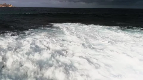 White big waves wash the stone coast of the island of Malta Shooting from drone Stock Footage 233064891
