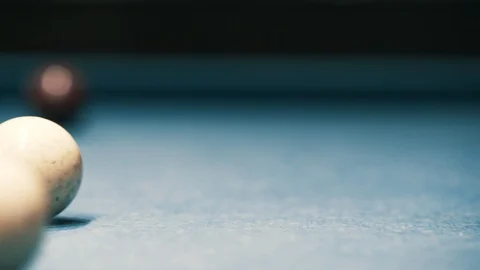 White billiard ball rolling down the table with a green cloth Video stock 99560628