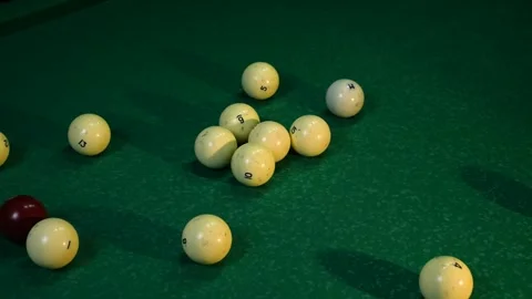 White billiard balls are folded into a triangle by male hands. On a green Stock Footage 241318683