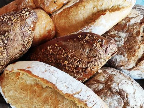 White, black, gray bread of different varieties on the table Stock Photos