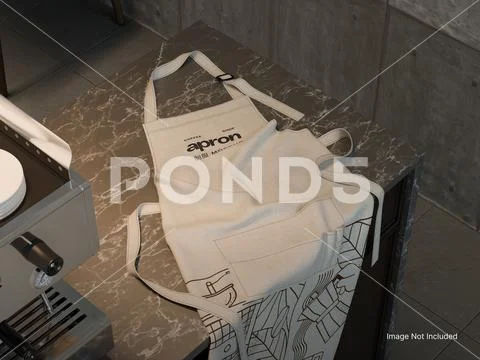 White Blank Apron Mockup on a Countertop beside Coffee Machine, Cafe Setting PSD Template