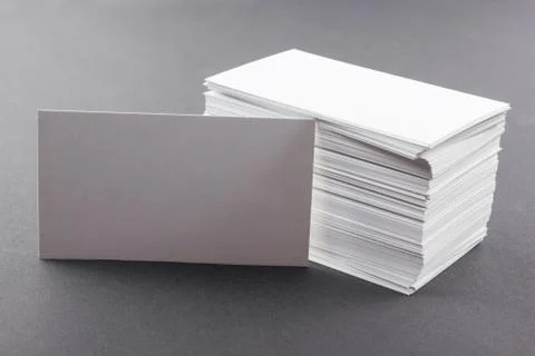 White blank business visit card, gift, ticket, pass on gray steel background Stock Photos