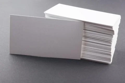 White blank business visit card, gift, ticket, pass on gray steel background Stock-Fotos