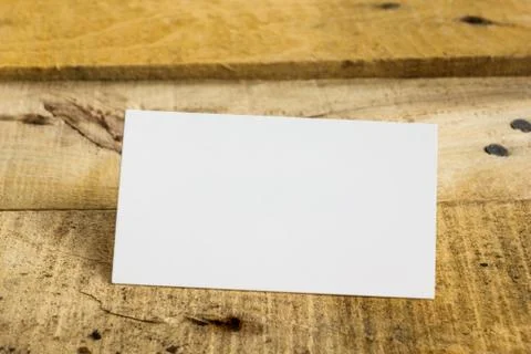 White blank business visit card, gift, ticket, pass, on wooden table Stock Photos