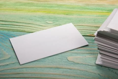 White blank business visit card, gift, ticket, pass, present close up on blurred Stock Photos