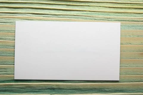 White blank business visit card, gift, ticket, pass, present close up on blurred Foto stock