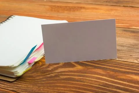 White blank business visit card, gift, ticket, pass, on wooden table Stock Photos