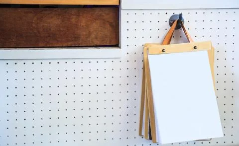 White Blank Empty Paper Pages on Clipboards Hanging on White Wall Stock Photos