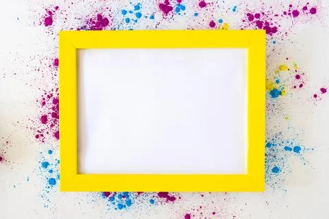 White blank frame with yellow border holi color powder white background Stock Photos