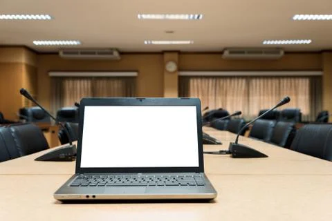 White Blank laptop computer placed on wooden meeting table in empty meeting r Stock Photos