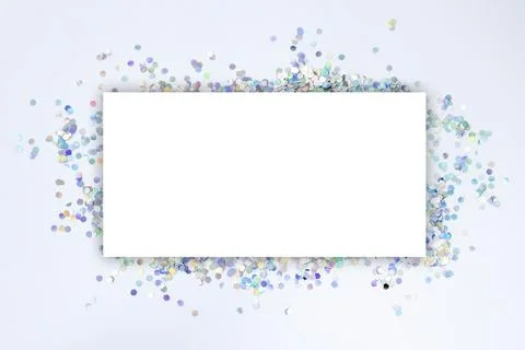 White blank mock-up sheet with a background of silver holographic confetti Stock Photos