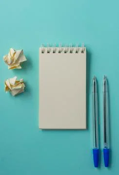 White blank Notepad on a blue background, office supplies Stock Photos