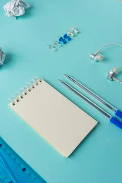 White blank Notepad on a blue background, office supplies Stock Photos