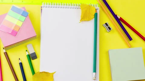 A white blank notepad lies on a pastel yellow background Video stock 158917159