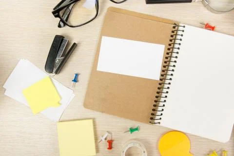 White blank open note book. Office table desk with set of colorful supplies, cup Stock-Fotos