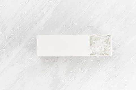 White blank open rectangle box with filler mock up on wood board top view for Stock Photos