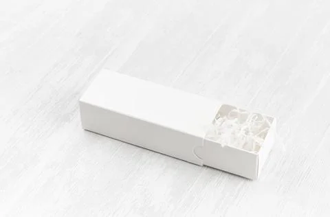 White blank open rectangle box with filler mock up on wood board side view fo Stock Photos
