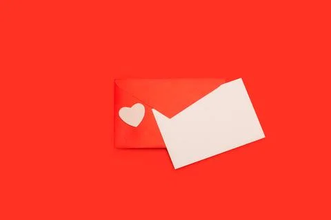 A white blank paper on an envelope wit a white paper heart on a red background Stock Photos