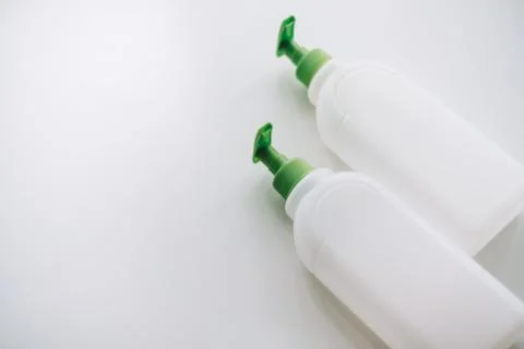 White blank plastic bottles for liquid soap or detergent on a white backgroun Stock Photos