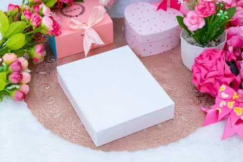 White blank rectangle box above a small tablecloth surrounded by valentine .. Stock Photos