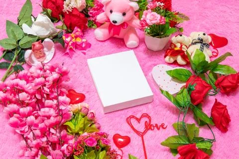 White blank rectangle box above a fluffy pink carpet surrounded by valentin.. Stock Photos