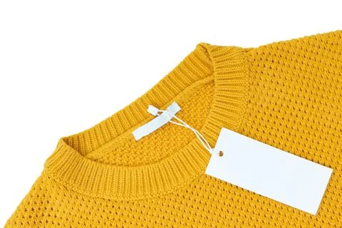 White blank rectangular clothing tag on yellow knitted sweater isolated on wh Stock Photos