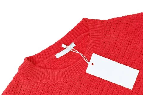 White blank rectangular clothing tag on yellow knitted sweater isolated on .. Stock Photos
