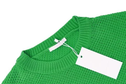White blank rectangular clothing tag on green knitted sweater isolated on w.. Foto stock