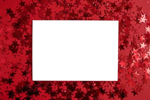 White blank rectangular paper on a red background with confetti in the form o Foto stock
