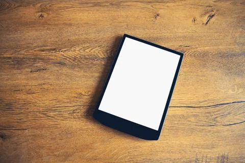 White blank screen digital tablet computer on wooden table at home, top view Stock Photos
