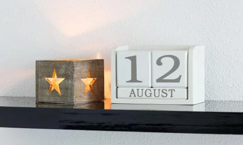 White block calendar present date 12 and month August Stock Photos