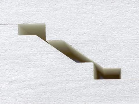 White blocks of a complex profile lie in stacks - close-up of decorative pane Stock Photos