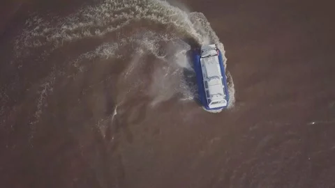 White blue hovercraft sails along river turning around Stock Footage 155286553