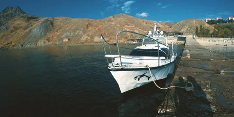 White boat moored to pier Stock Footage 84548359