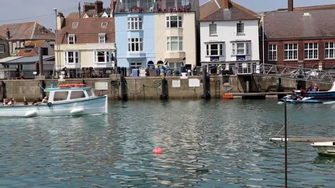 White boat passing left to right harbour background Stock-Footage 137232491