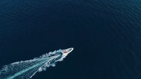 White boat sails at high speed leaving a trail. Aerial view Video stock 80710817