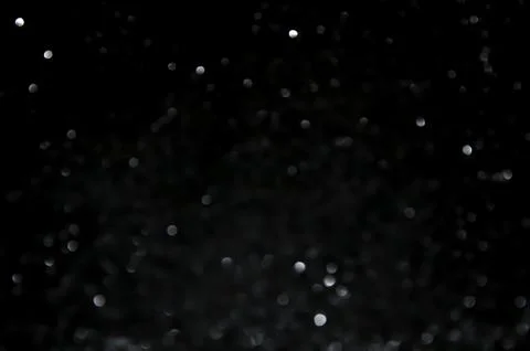 White bokeh on a black background. Stock Photos