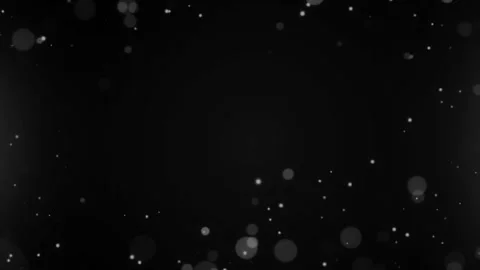 White bokeh particles floating on black background cinematic footage. Stock Footage 342753426