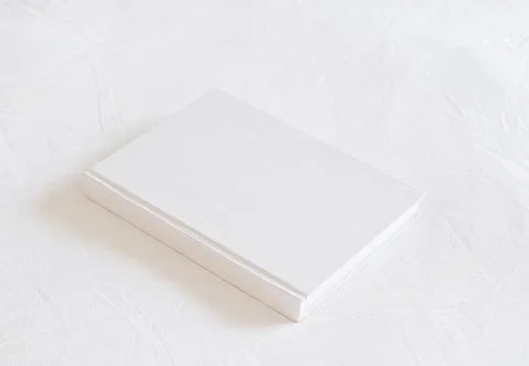 White book mockup on white bed Stock Photos