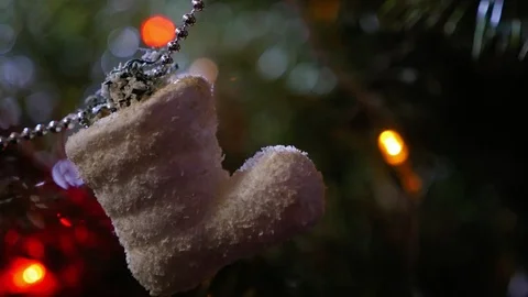 White boot toy hangs on the Christmas tree, close up Видео 101063689