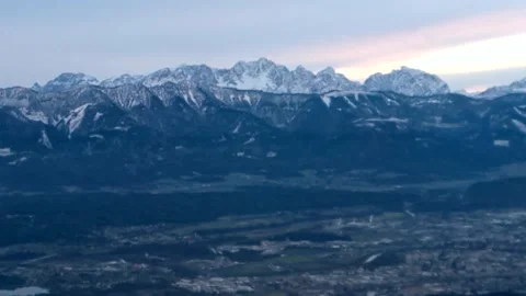 White border lies snow on high mountains mountain peaks green donuts Stock Footage 256794023