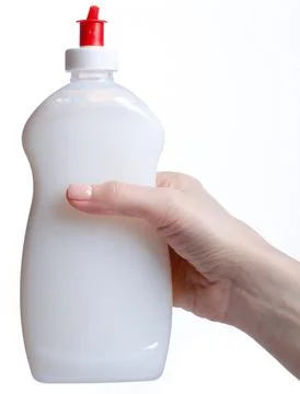 White bottle dish detergent in hand Stock Photos